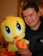 This picture shows a big-headed simple creature and Tweety Pie...